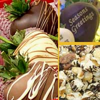 Delivered gift of fancy chocolate covered strawberries with chocolate drizzled popcorn and nuts decorated for the Holidays