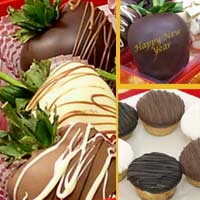 Delivered gift of fancy chocolate covered strawberries with mini-cheesecakes decorated for new years parties
